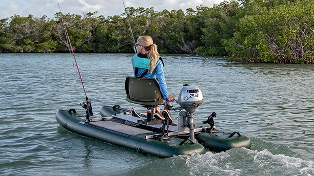a woman sailing a small boat on a lake